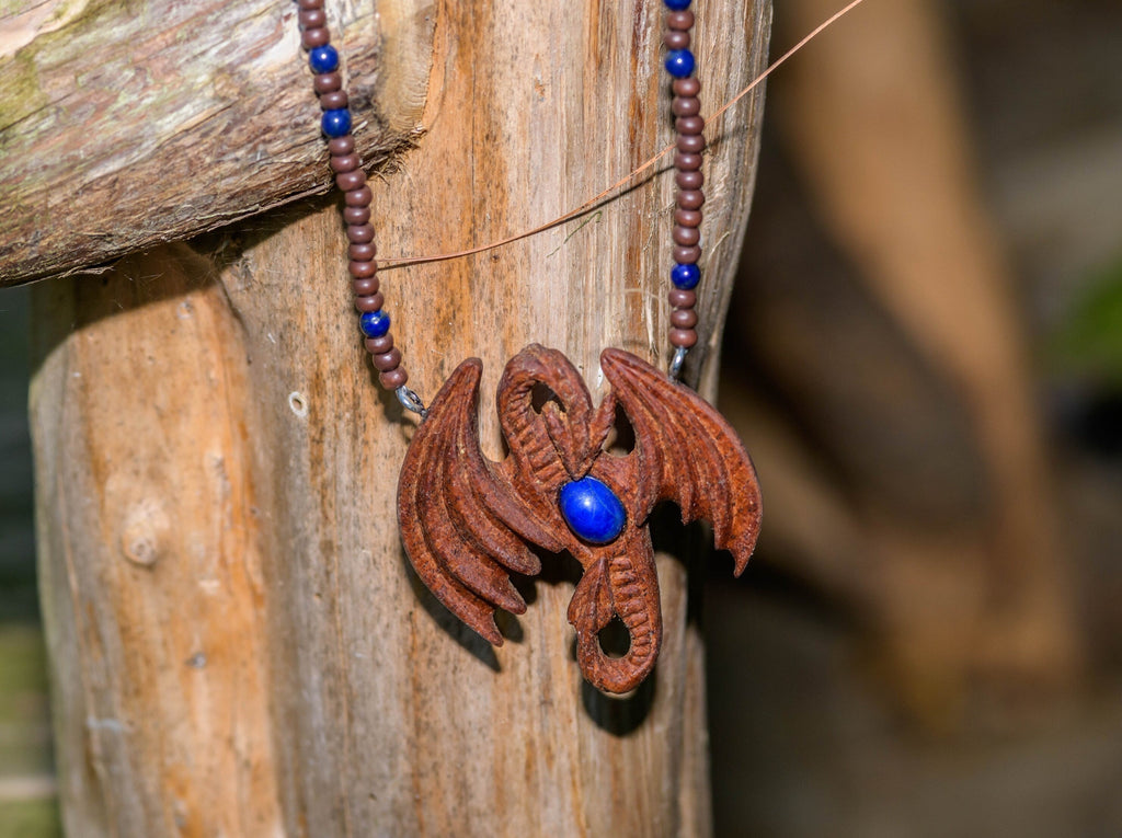 Hand-carved Dragon pendant of African Mahogany with genuine Lapis Lazuli on a wood and lapis lazuli necklace