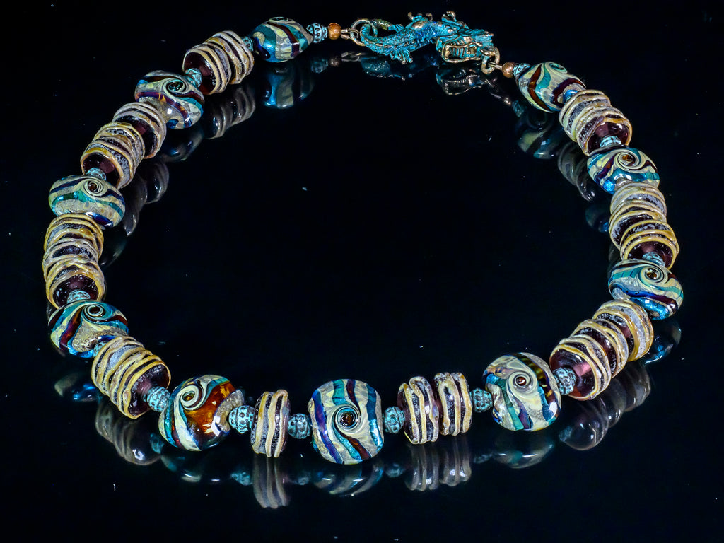 A Necklace of Murano Glass and Handmade Lampwork Designer Glass beads in Teal, Amethyst and Brown Tones