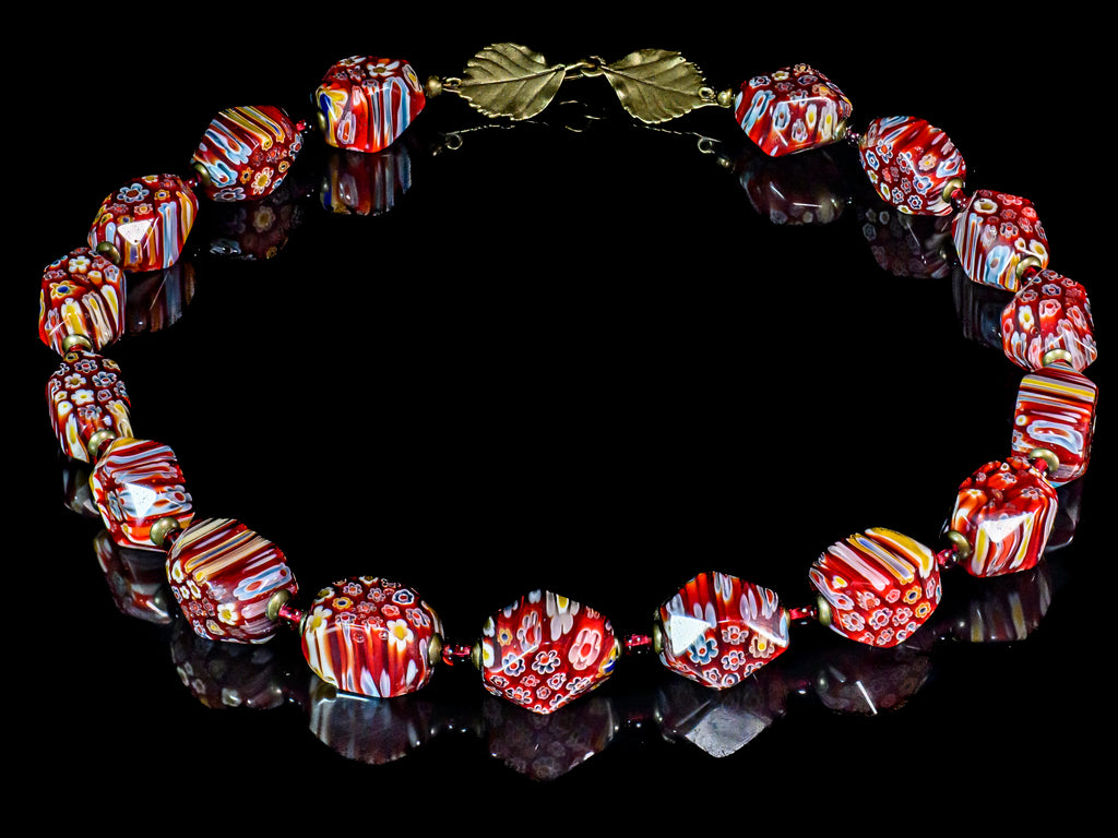 A Necklace of Artisan Lamp Worked Faceted Millefiori Glass Beads