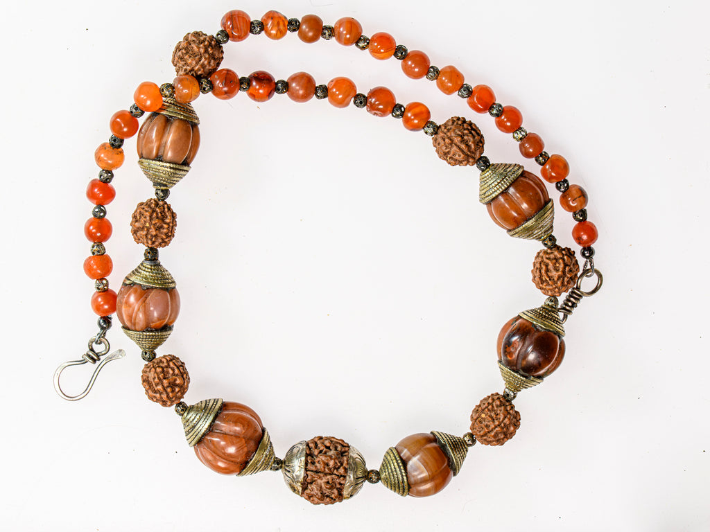A Necklace of Tibetan Capped Melon Carnelian Agate and Rudraksha Nut Beads
