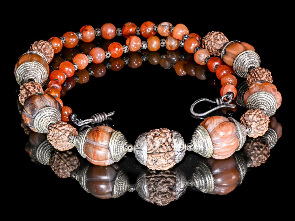 A Necklace of Tibetan Capped Melon Carnelian Agate and Rudraksha Nut Beads