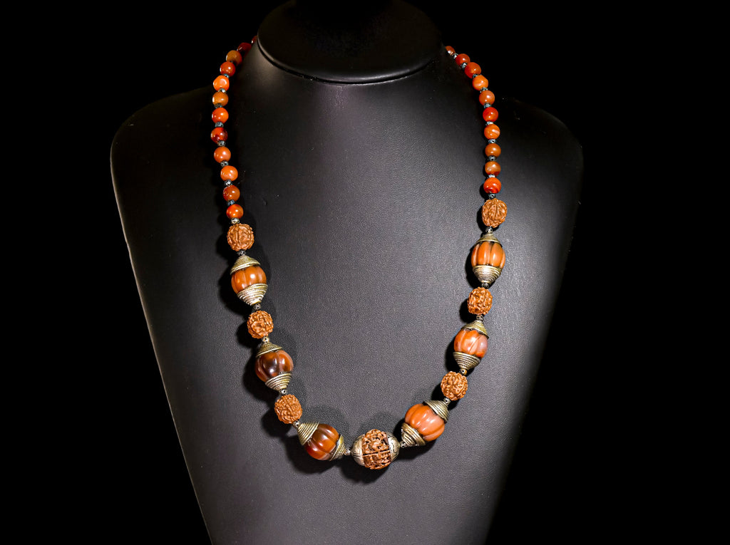 A Necklace of Tibetan Capped Melon Carnelian Agate and Rudraksha Nut Beads