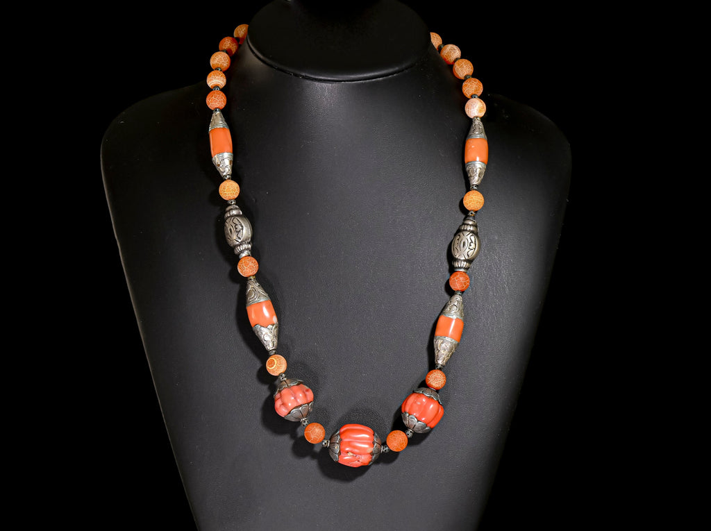 A Necklace of Tibetan Capped Faux Coral Beads, old coin silver from India, and Crackled Agate