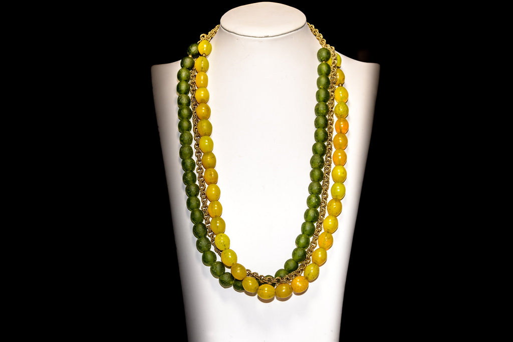 A Triple-strand Necklace of Antique yellow "tomato" Bohemian Trade beads, Krobo Recycled Glass,  and  African Brass