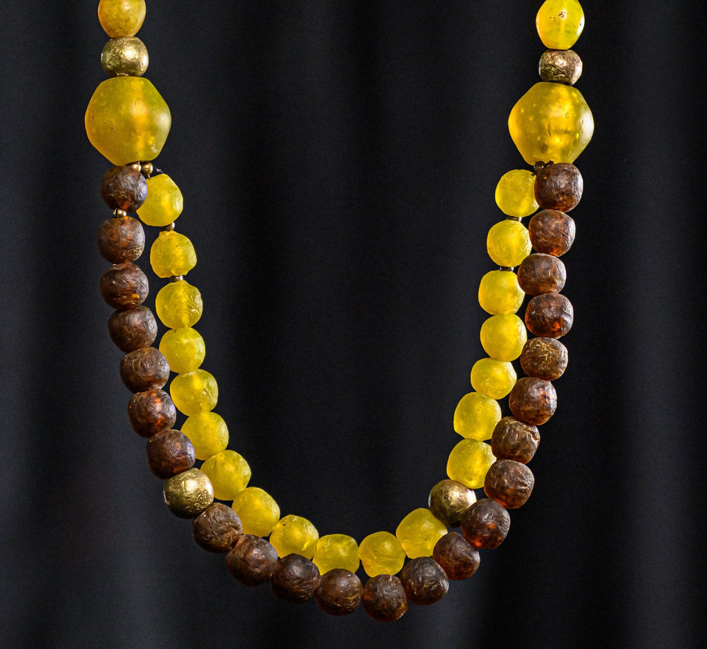 A Double-Strand Necklace of Krobo Glass, Antique Yellow "Tomato" Bohemian Trade Beads,  and Nigerian Brass Globe Beads