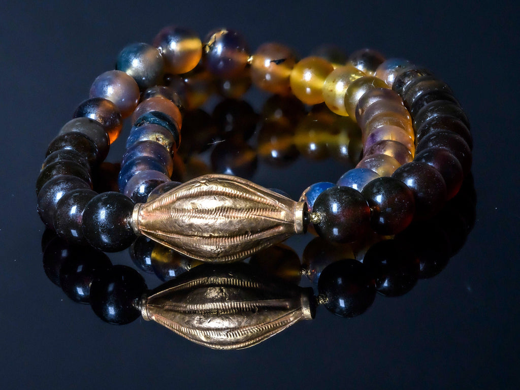 A Long Necklace of Indonesian Amber in Gold and Honey Hues